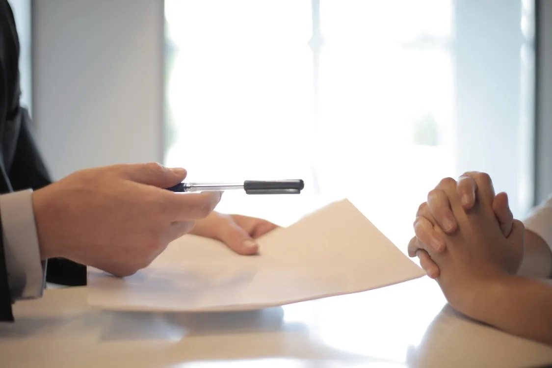 Business professional signing a seller note agreement in an M&A deal