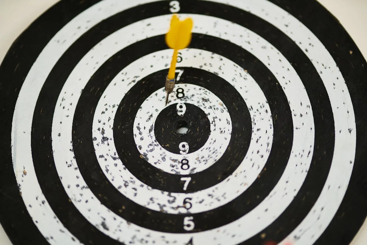 Dart hitting bullseye on dartboard representing targeted buyer outreach in tech M&A