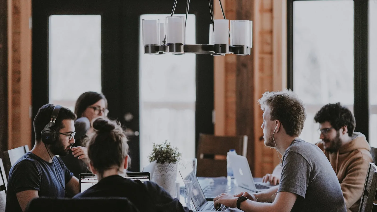 SaaS team working together before an acquisition, representing key employee retention and stay bonuses